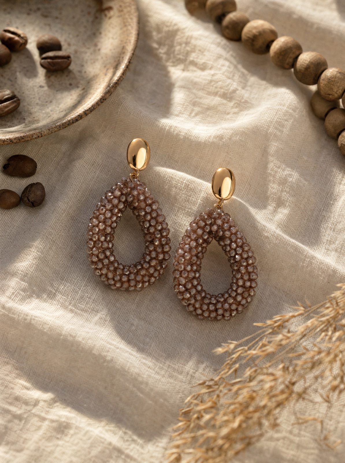 amalfi drops in brown on cream linen with coffee beans and wooden beads