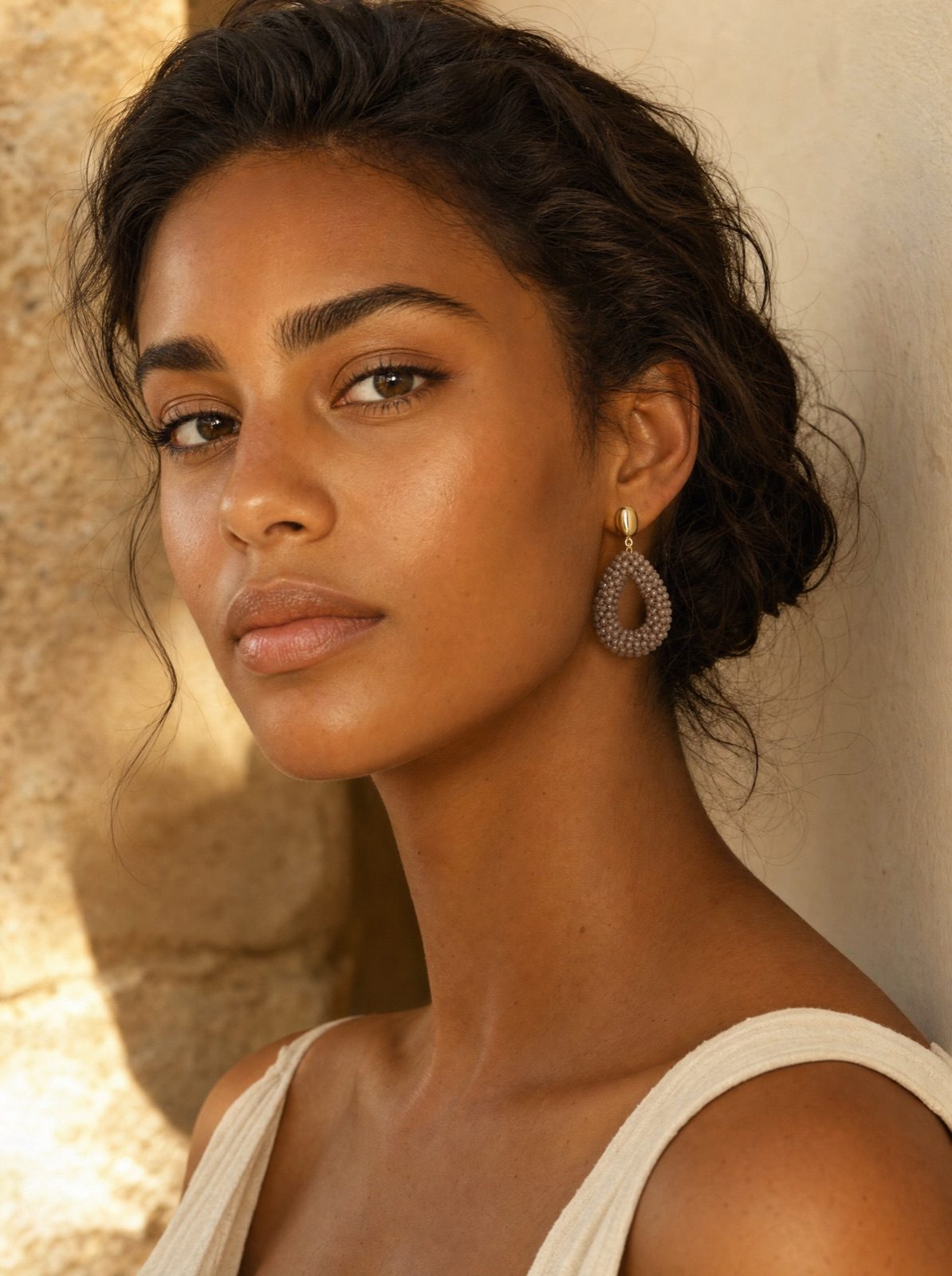 woman wearing the amalfi drops in brown, side profile in warm afternoon light