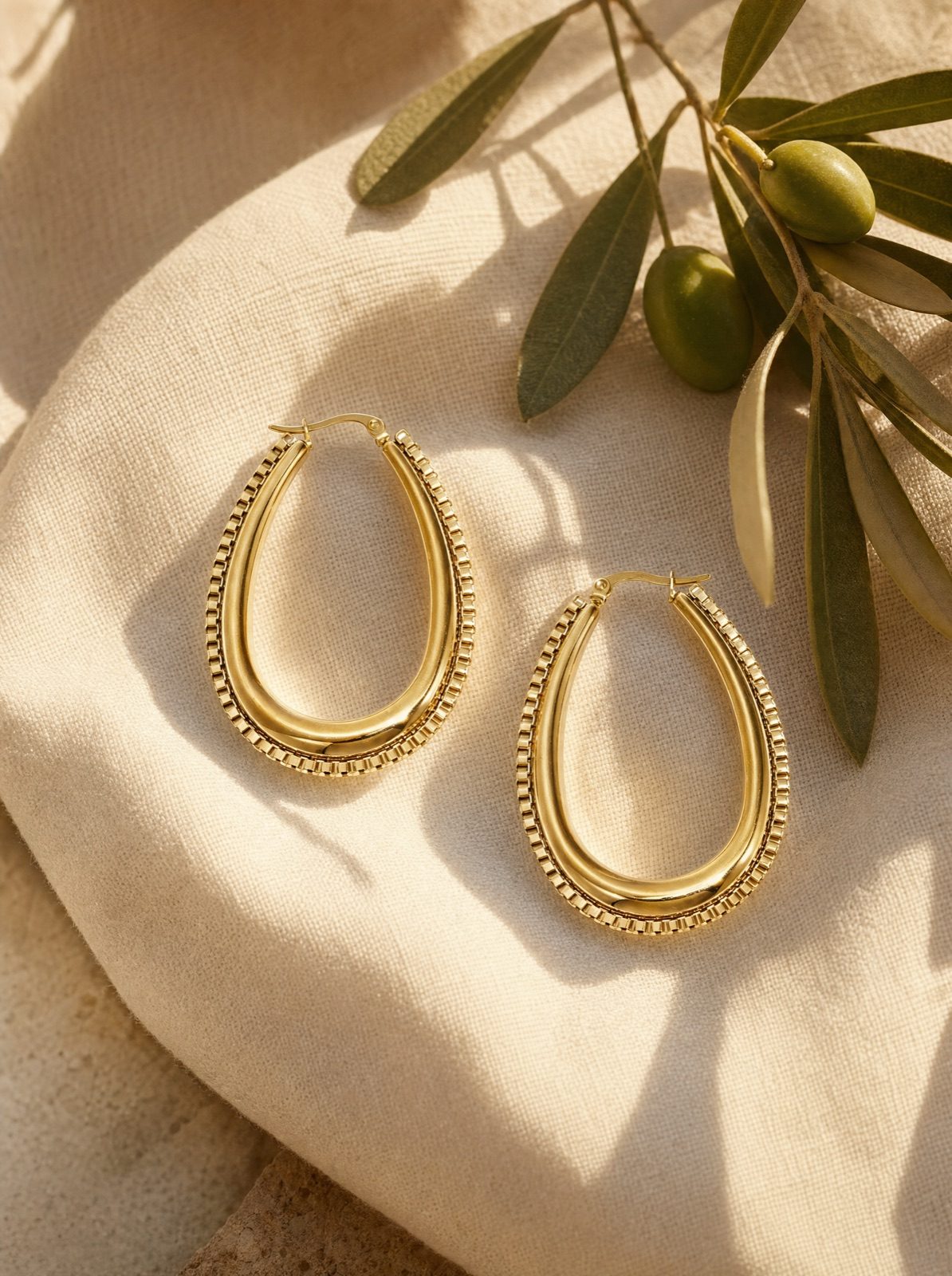 link drop earrings in gold on cream linen