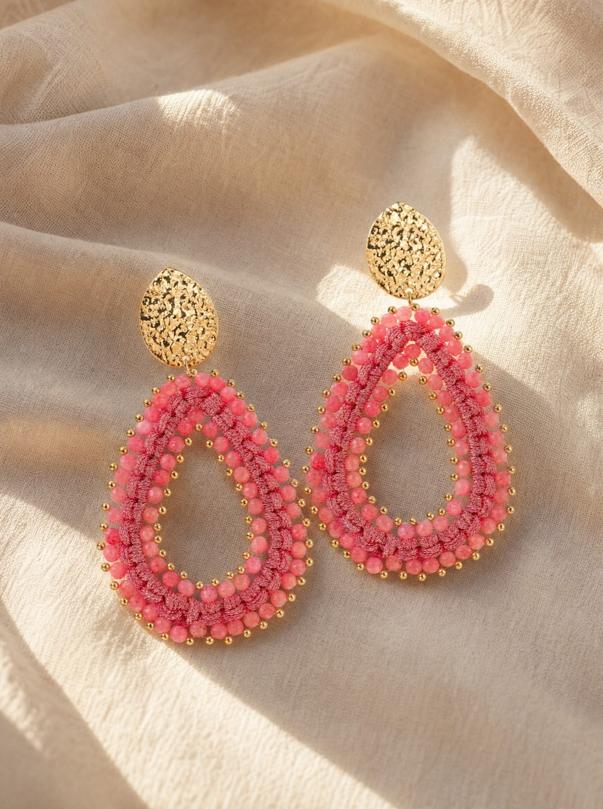 riviera drops in coral on folded cream linen