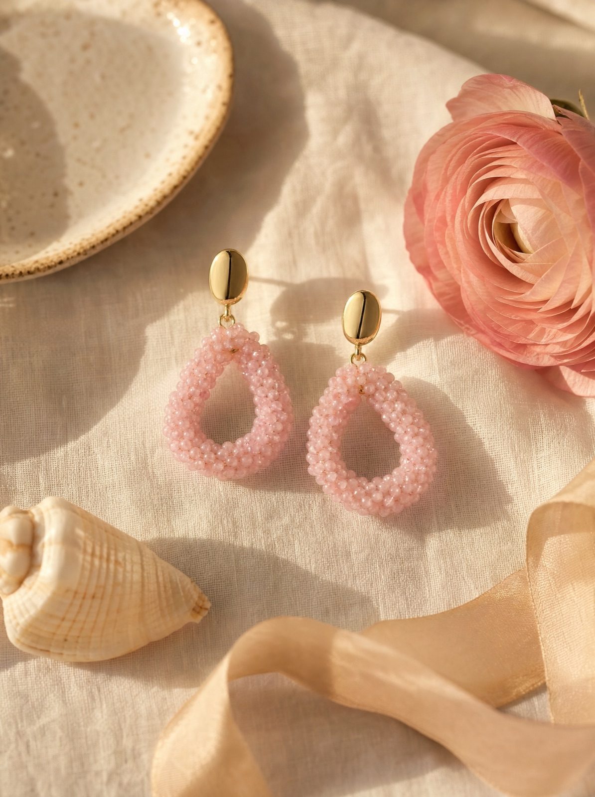 amalfi drops in pink on cream linen with a ranunculus and silk ribbon