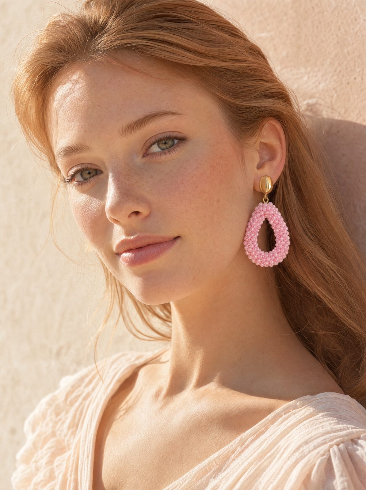 woman wearing the amalfi drops in pink, side profile in soft afternoon light