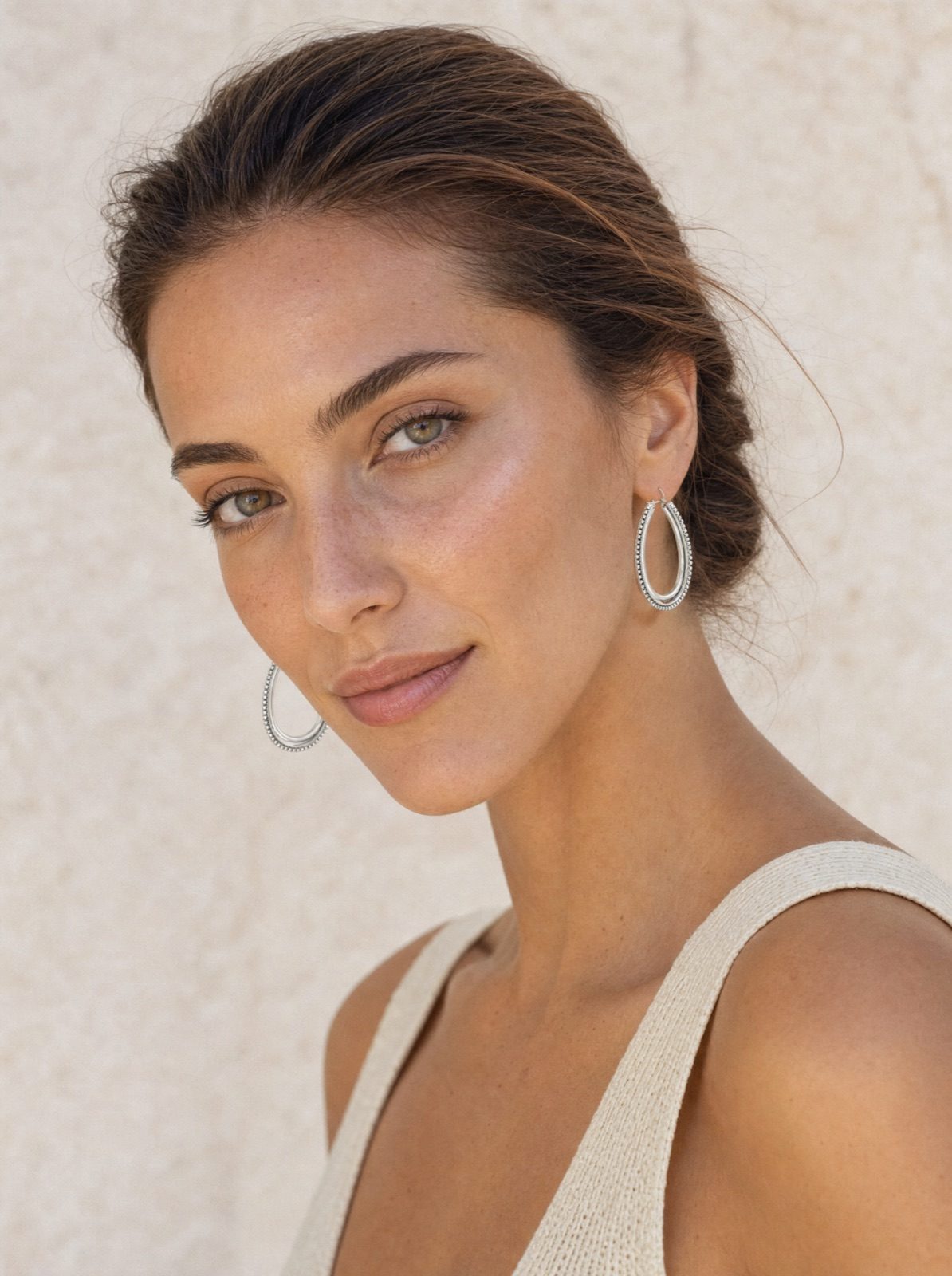 woman wearing the link drop earrings in silver, side profile