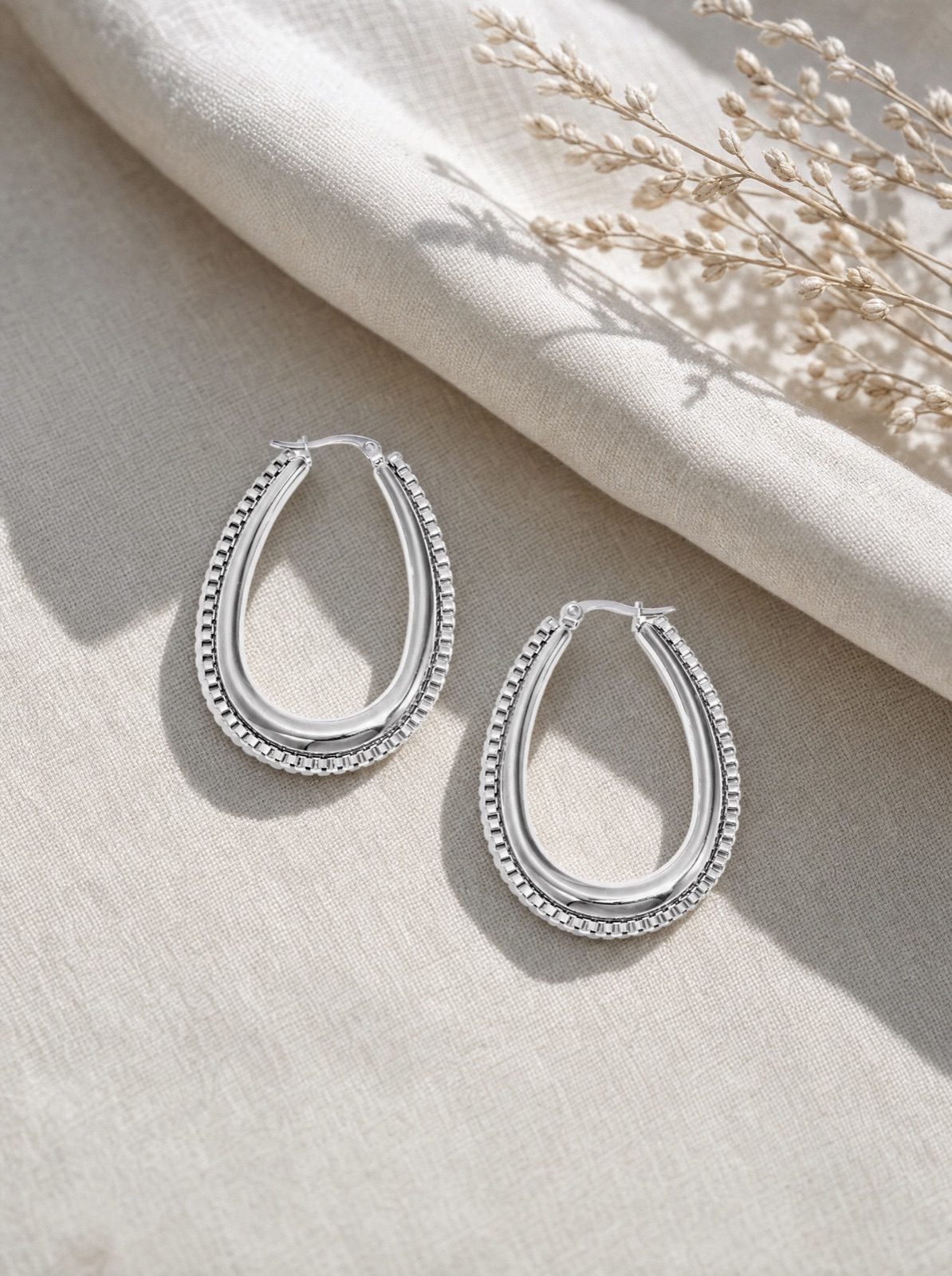 link drop earrings in silver on cream linen