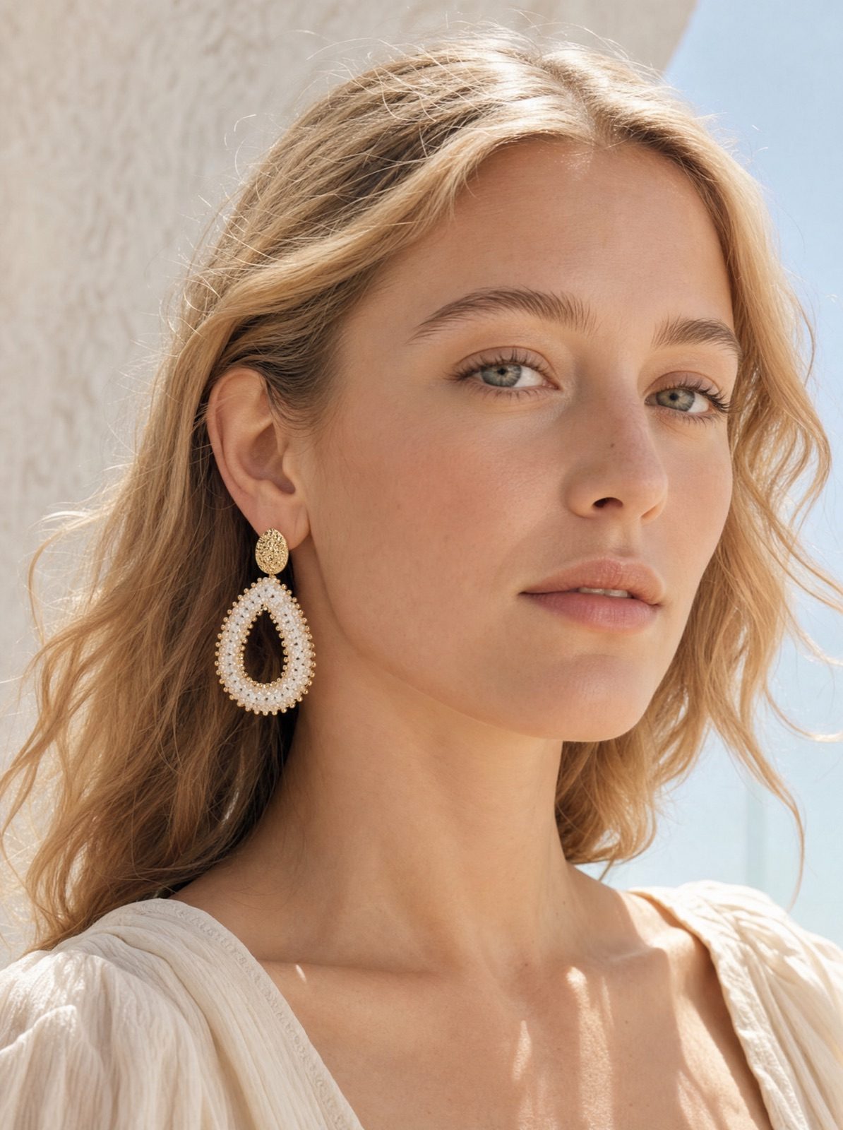 woman wearing the riviera drops in pearl white, side profile in soft afternoon light